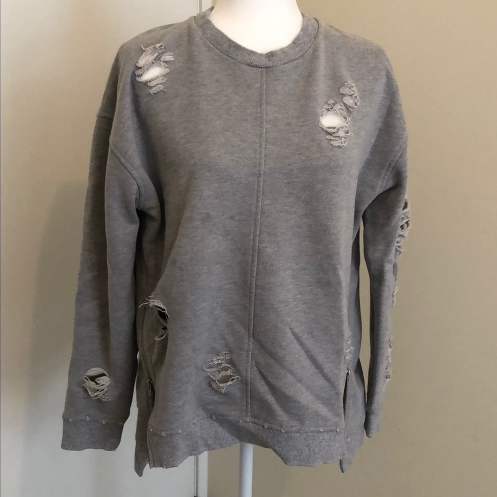 Joe’s ripped gray sweatshirt.